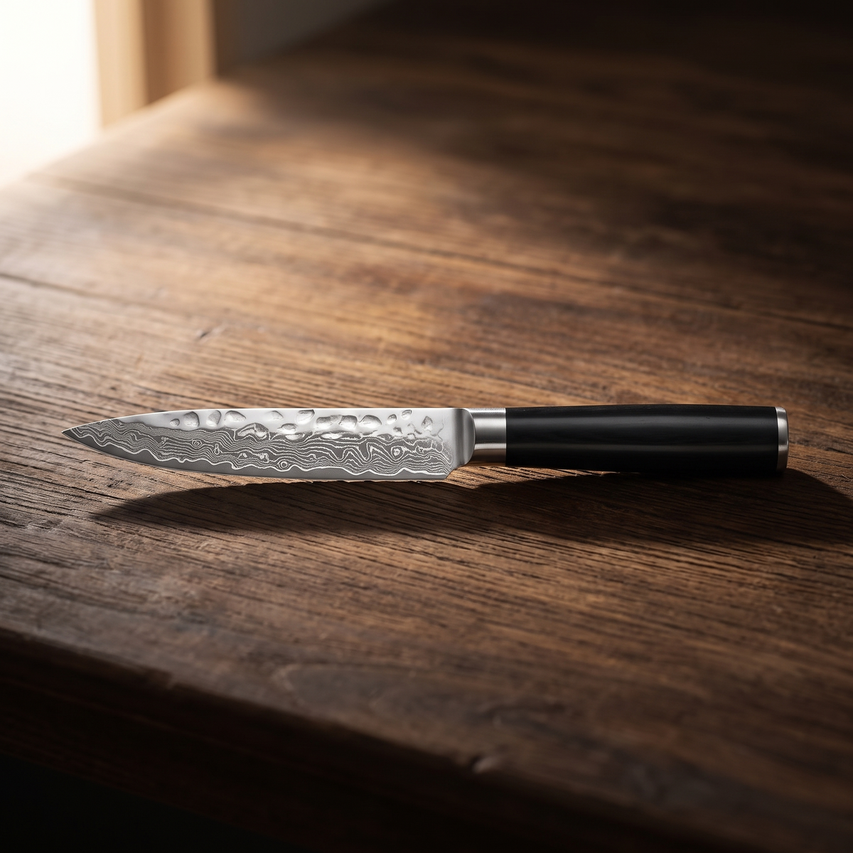 Izarsi Damascus Fillet Paring Knife - resting on dark wood counter